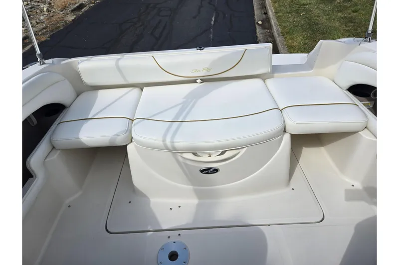 Slide: The Image of 2002 Sea Ray 225 Weekender boat interior with white cushioned seating. - 20