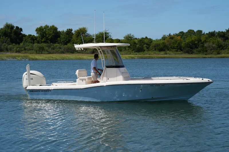 Slide: The Image of 2024 Grady-White 251 Coastal Explorer boat cruising on a serene lake. - 10