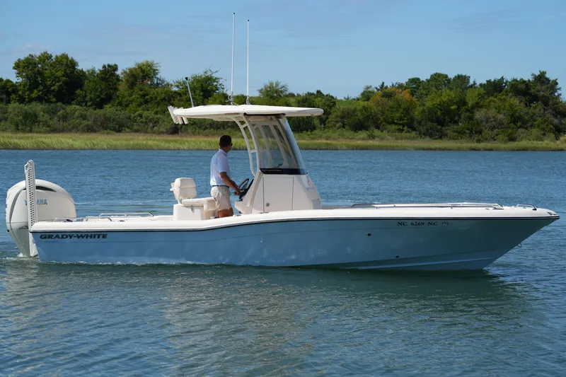 Slide: The Image of 2024 Grady-White 251 Coastal Explorer boat cruising on a serene lake. - 11