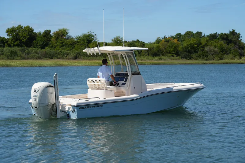 Slide: The Image of 2024 Grady-White 251 Coastal Explorer boat cruising on a serene lake. - 12