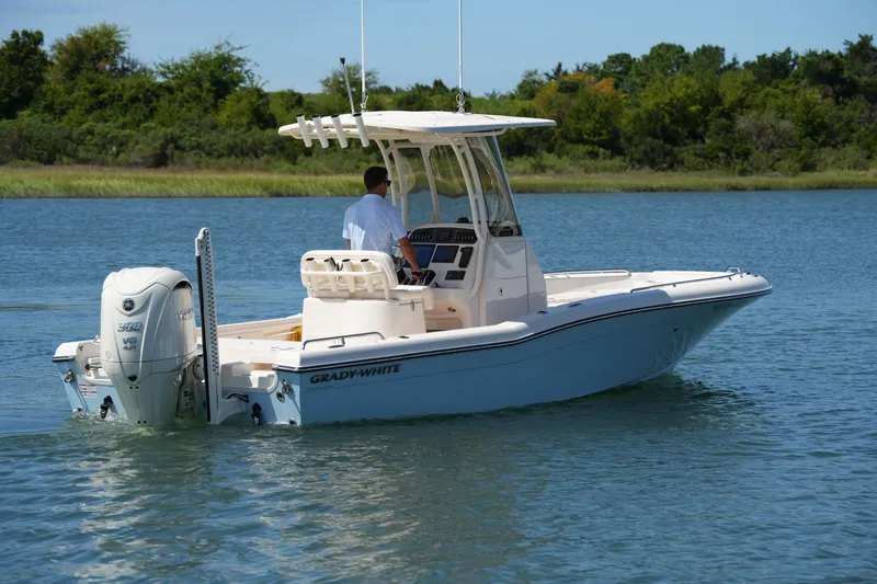 Slide: The Image of 2024 Grady-White 251 Coastal Explorer boat cruising on a serene lake. - 13