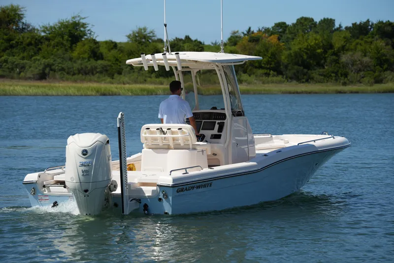 Slide: The Image of 2024 Grady-White 251 Coastal Explorer boat cruising on a serene lake. - 14
