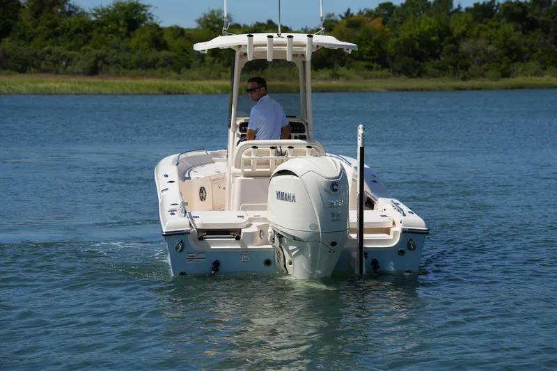 Slide: The Image of 2024 Grady-White 251 Coastal Explorer boat cruising on a serene lake. - 16