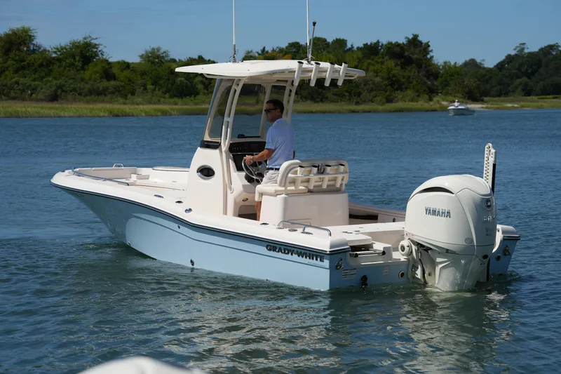 Slide: The Image of 2024 Grady-White 251 Coastal Explorer boat cruising on a serene lake. - 17