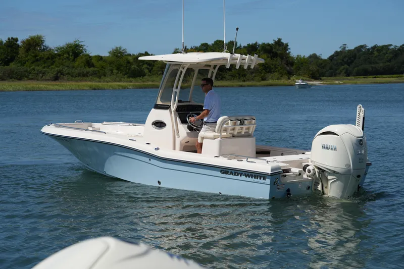 Slide: The Image of 2024 Grady-White 251 Coastal Explorer boat cruising on a serene waterway. - 18