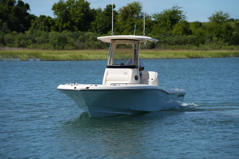 Slide: The Image of 2024 Grady-White 251 Coastal Explorer boat cruising on a serene lake. - 2