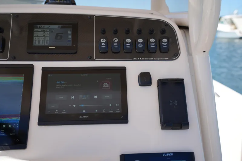 Slide: The Image of 2024 Grady-White 251 Coastal Explorer dashboard with Garmin and Yamaha displays. - 27