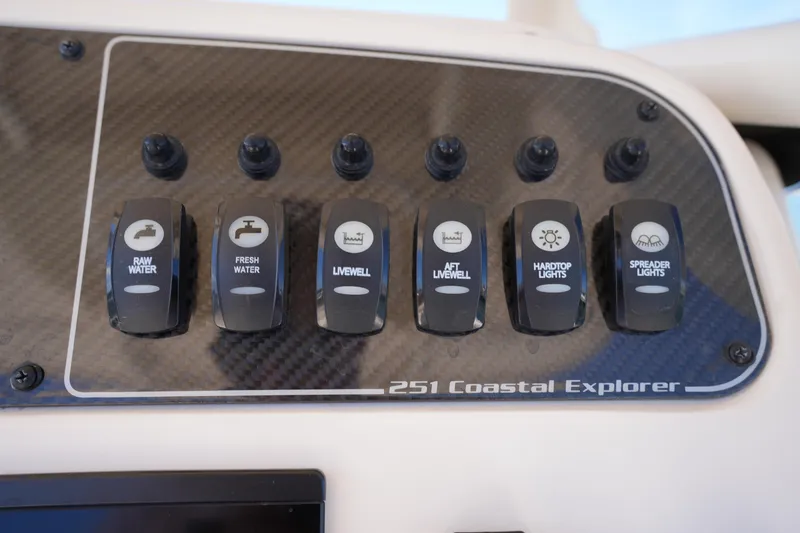Slide: The Image of Control panel of 2024 Grady-White 251 Coastal Explorer with various switches. - 30