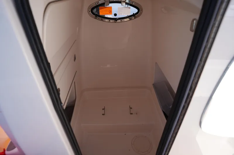 Slide: The Image of 2024 Grady-White 251 Coastal Explorer interior cabin with porthole window. - 35