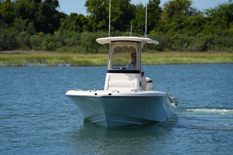Slide: The Image of 2024 Grady-White 251 Coastal Explorer boat cruising on a serene waterway. - 4