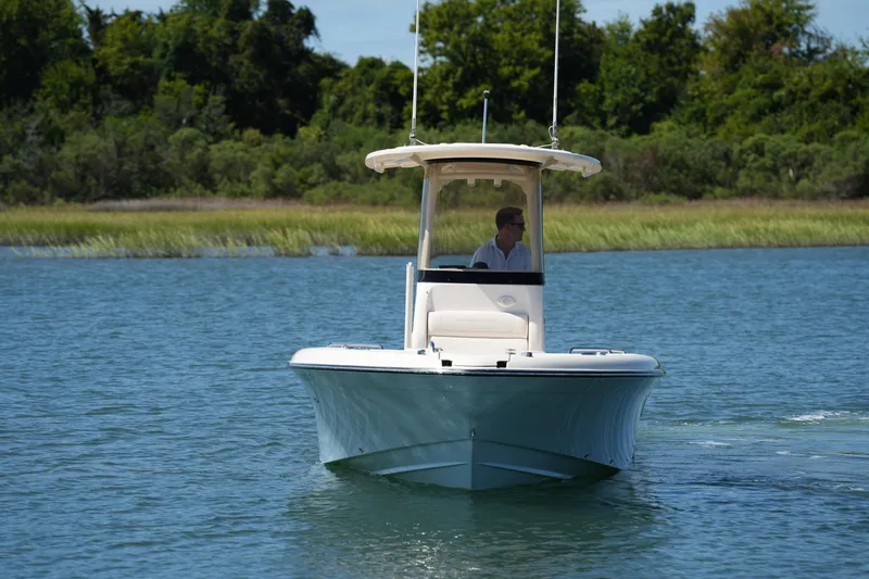 Slide: The Image of 2024 Grady-White 251 Coastal Explorer boat cruising on a serene lake. - 5