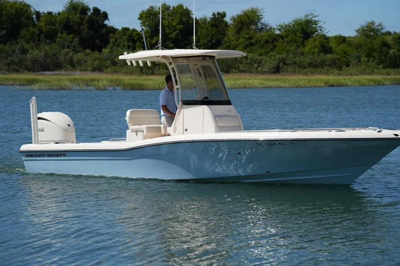 Slide: The Image of 2024 Grady-White 251 Coastal Explorer boat cruising on a serene lake. - 8