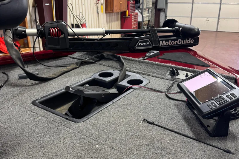 Slide: The Image of 2021 Bass Tracker Pro Team 195 boat interior with MotorGuide trolling motor and fish finder. - 4