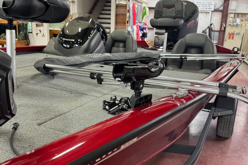 Slide: The Image of 2021 Bass Tracker Pro Team 195 boat interior with fishing rod holders and seating. - 6