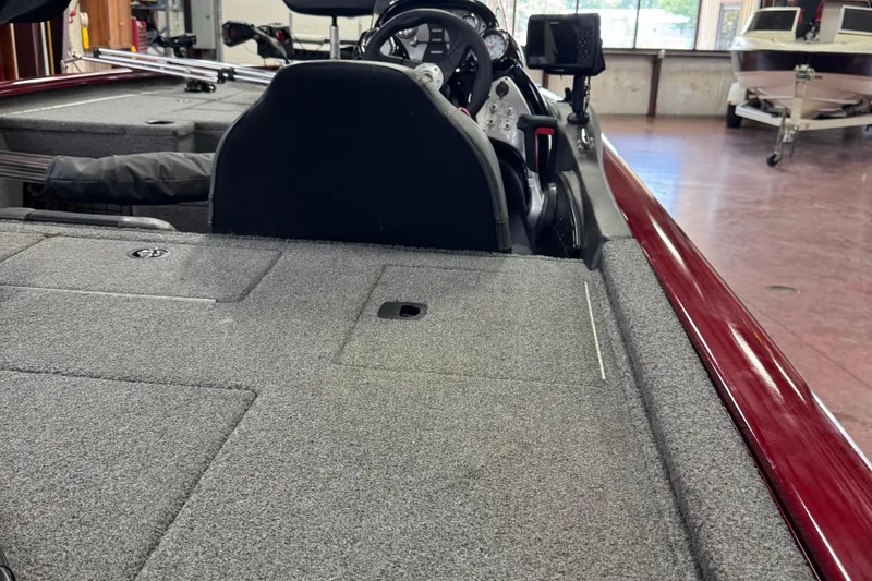 Slide: The Image of 2021 Bass Tracker Pro Team 195 boat interior with carpeted deck and steering console. - 7