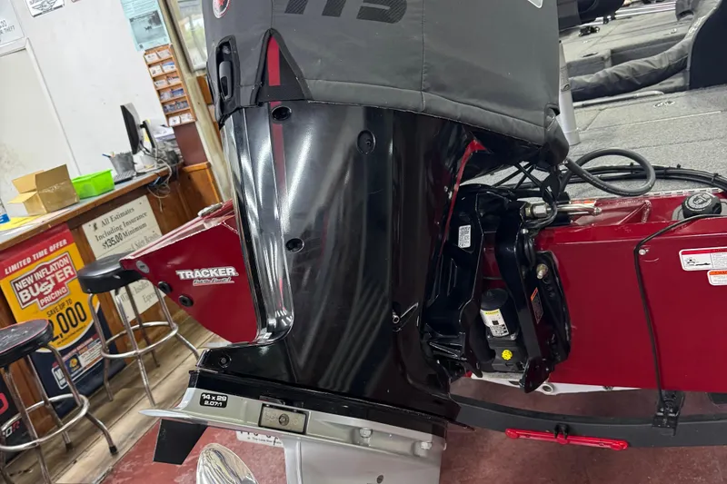 Slide: The Image of 2021 Bass Tracker Pro Team 195 boat engine in a showroom setting. - 9