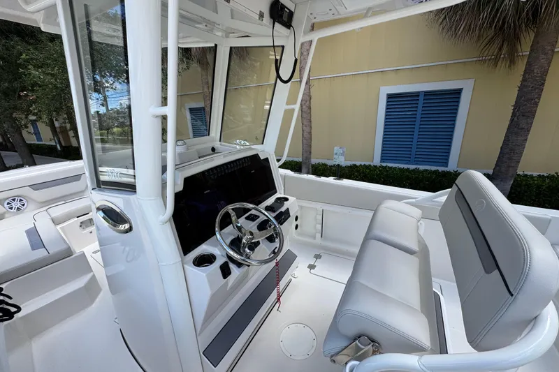 Slide: The Image of Interior view of 2026 Sailfish 252 boat, featuring modern steering console and seating. - 13
