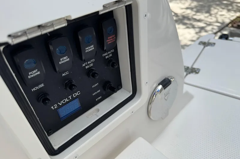 Slide: The Image of Control panel of 2026 Sailfish 252 boat featuring 12-volt DC switches and indicators. - 23