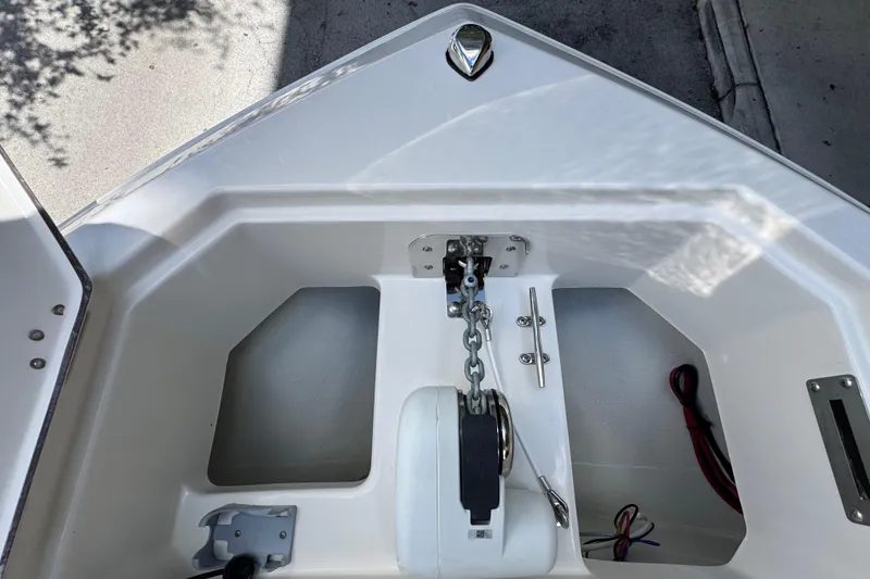 Slide: The Image of 2026 Sailfish 252 boat anchor compartment with chain and winch system. - 8