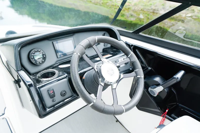 Slide: The Image of 2023 Yamaha Boats SX195 steering console with modern controls and sleek design. - 12