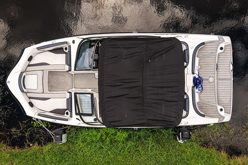 Slide: The Image of Top view of 2023 Yamaha SX195 boat docked by the water. - 3