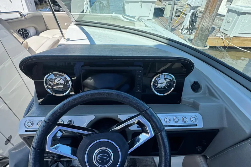 Slide: The Image of Dashboard of 2022 Crownline Eclipse E235 XS boat with steering wheel and gauges. - 15