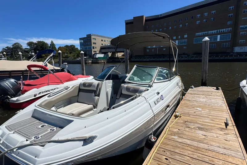 Slide: The Image of 2022 Crownline Eclipse E235 XS boat docked beside wooden pier on a sunny day. - 3