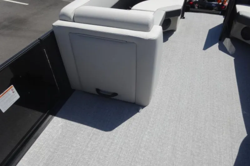 Slide: The Image of 2026 Harris Cruiser 230 Heritage boat interior with gray seating and flooring. - 10