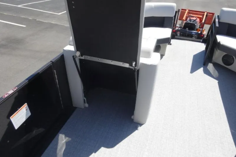 Slide: The Image of 2026 Harris Cruiser 230 Heritage interior with seating and open storage compartment. - 11