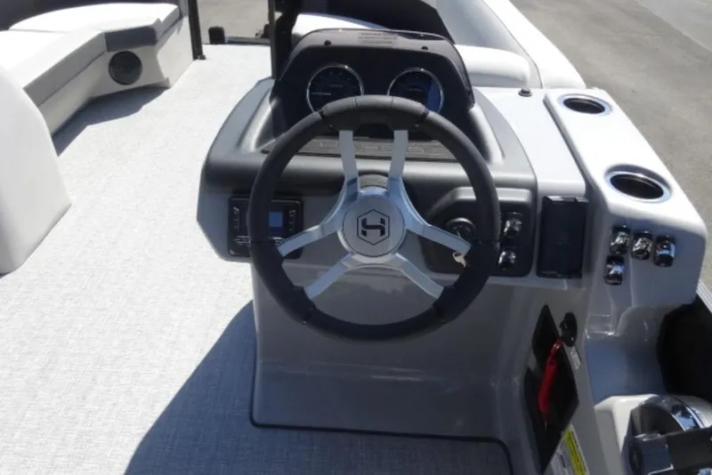 Slide: The Image of 2026 Harris Cruiser 230 Heritage boat dashboard with steering wheel and controls. - 12