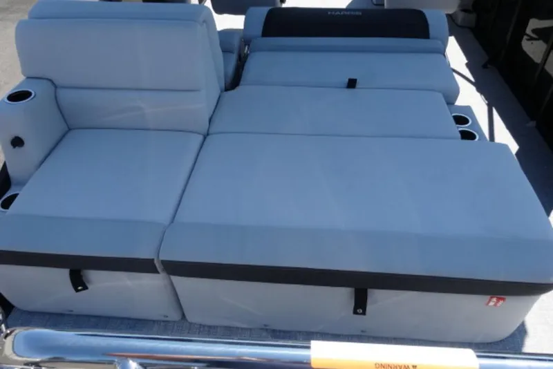 Slide: The Image of 2026 Harris Cruiser 230 Heritage boat seating with cup holders, featuring light gray upholstery. - 14