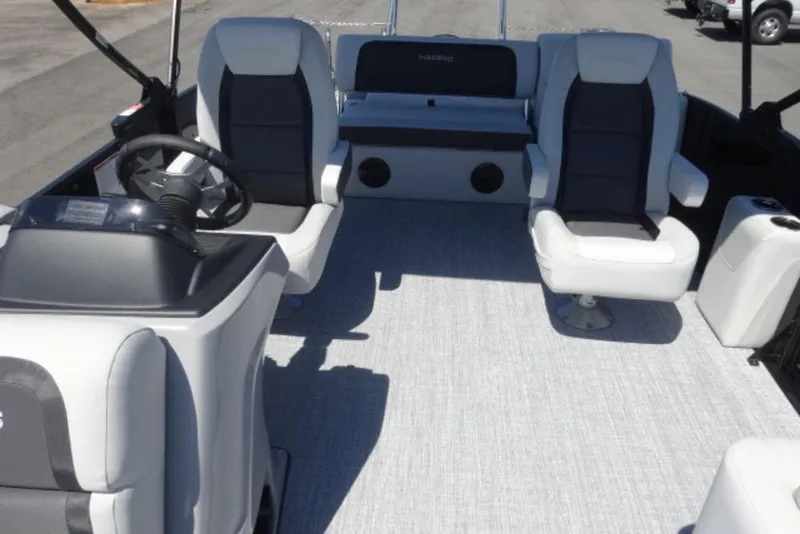 Slide: The Image of 2026 Harris Cruiser 230 Heritage interior with plush seating and modern helm. - 4