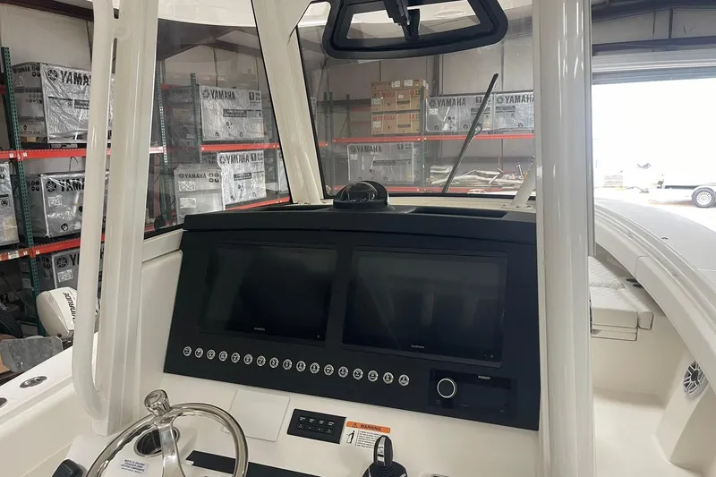 Slide: The Image of 2026 Regulator 31 boat dashboard with dual screens and Yamaha equipment in background. - 10