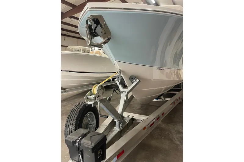 Slide: The Image of 2026 Regulator 31 boat on trailer in storage facility. - 12