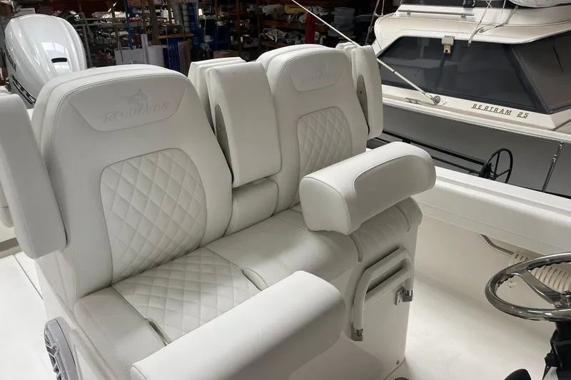 Slide: The Image of Luxurious white seating on 2026 Regulator 31 boat, featuring diamond-stitched upholstery. - 13