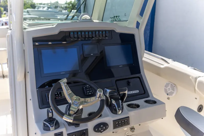 Slide: The Image of 2022 Sailfish 272 CC boat with foldable seat and measuring ruler on deck. - 10