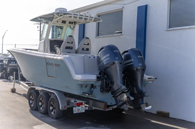 Slide: The Image of 2022 Sailfish 272 CC boat interior with dual helm seats and control panel. - 11