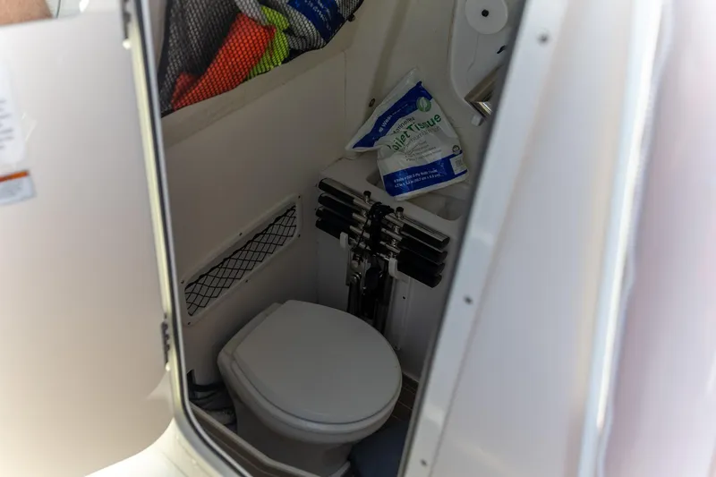 Slide: The Image of 2022 Sailfish 272 CC boat dashboard with steering wheel and electronic displays. - 12