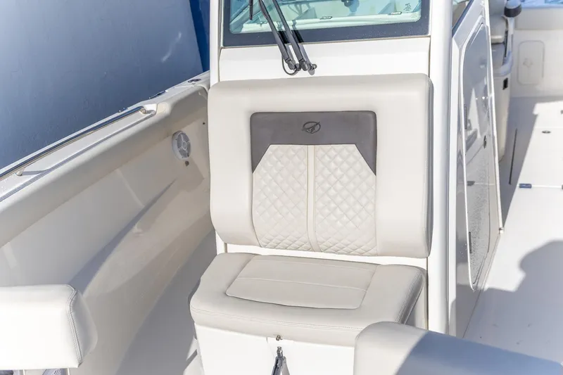 Slide: The Image of Interior of 2022 Sailfish 272 CC boat featuring compact marine toilet. - 4