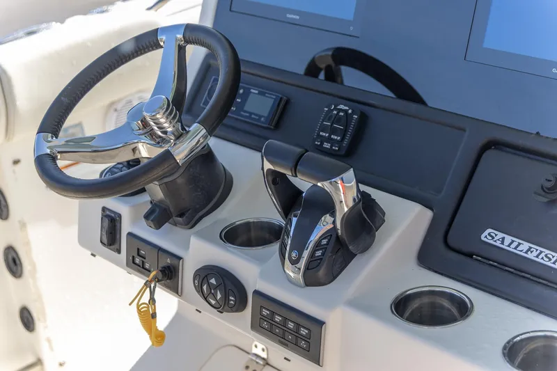 Slide: The Image of 2022 Sailfish 272 CC boat on trailer outside a building. - 6