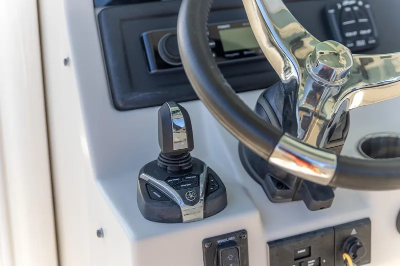 Slide: The Image of 2022 Sailfish 272 CC boat with sleek blue exterior and logo detail. - 7