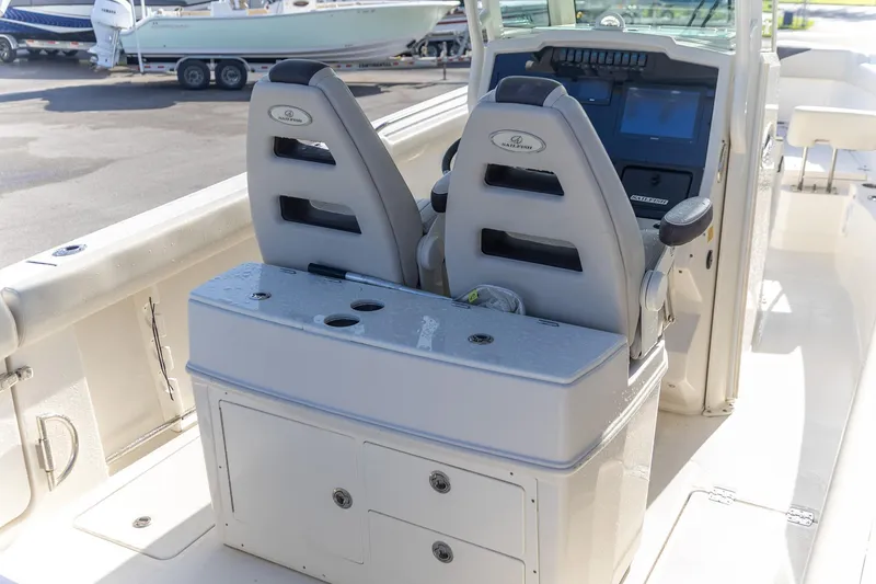 Slide: The Image of 2022 Sailfish 272 CC boat dashboard with steering wheel and controls. - 9