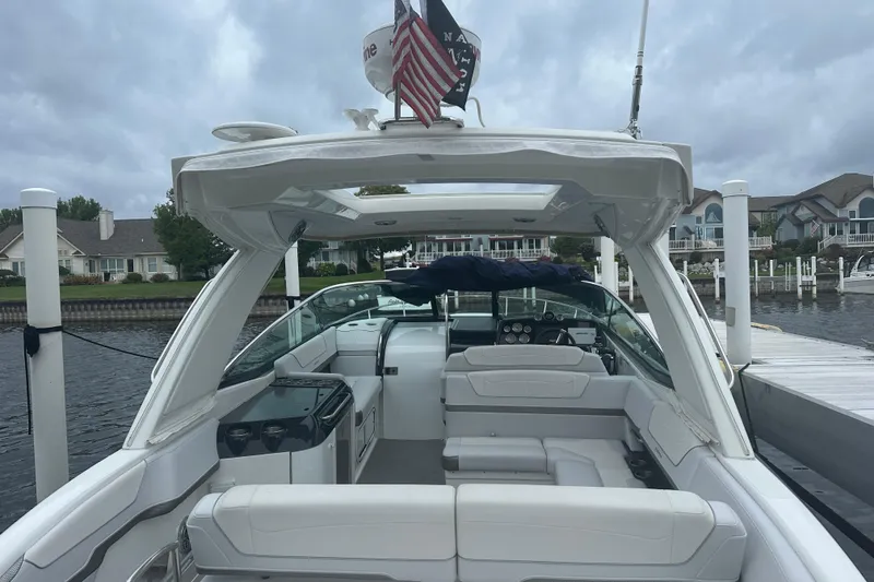 Slide: The Image of 2021 Formula 350 Sun Sport boat docked at marina, featuring spacious seating and modern design. - 12