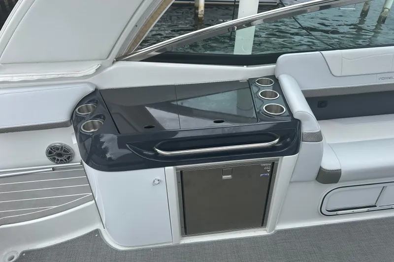 Slide: The Image of 2021 Formula 350 Sun Sport boat interior with cup holders and storage. - 17