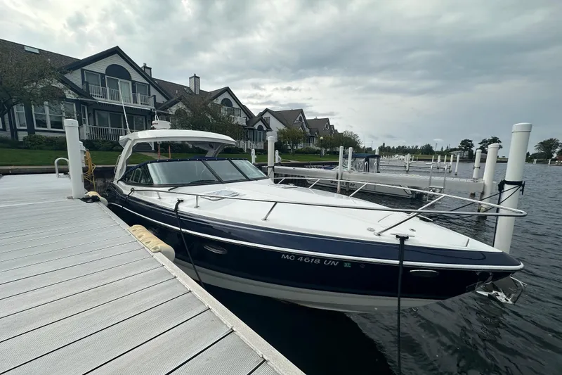Slide: The Image of 2021 Formula 350 Sun Sport docked at a marina with waterfront homes. - 2