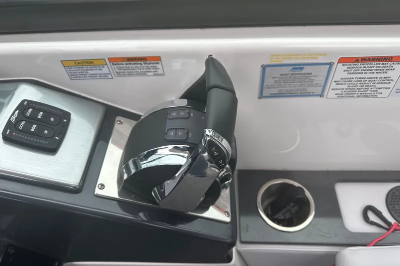 Slide: The Image of Control panel of 2021 Formula 350 Sun Sport boat with throttle and warning labels. - 26