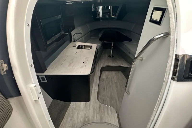 Slide: The Image of Interior of a 2021 Formula 350 Sun Sport boat with kitchenette and seating area. - 29