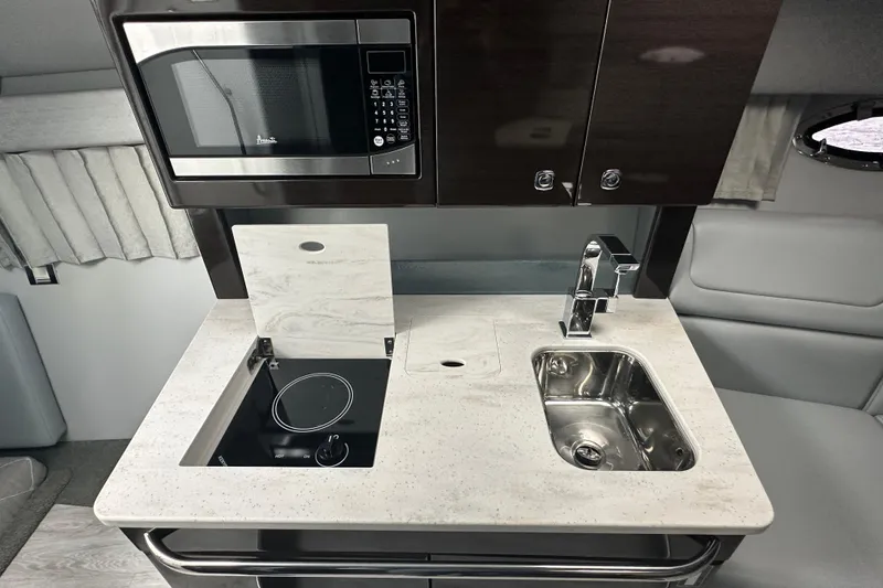 Slide: The Image of Modern kitchenette in 2021 Formula 350 Sun Sport with microwave, stove, and sink. - 32