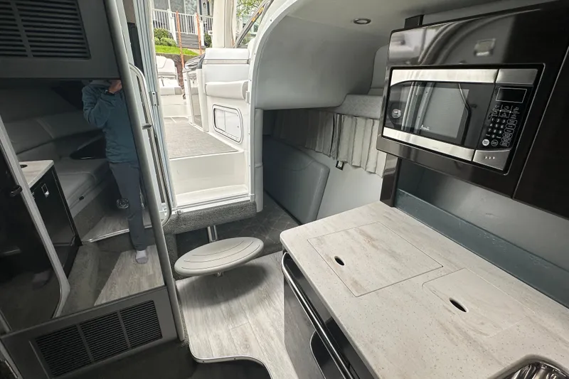 Slide: The Image of Interior of 2021 Formula 350 Sun Sport boat with kitchenette and seating area. - 35