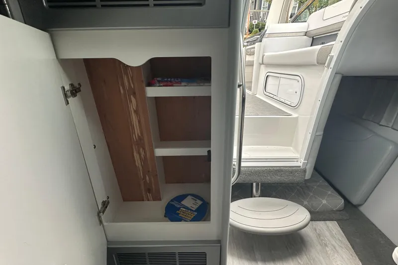 Slide: The Image of Interior of 2021 Formula 350 Sun Sport boat showing open cabinet and seating area. - 37